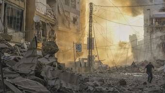 A man runs for cover as a smoke raises in the background following an Israeli airstrike in Dahieh, Beirut, Lebanon, on October 4. AP