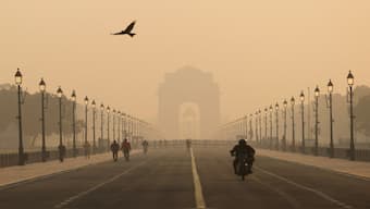 People walk on Kartavyapath near India Gate on a hazy morning in New Delhi, India, November 1, 2024. Reuters