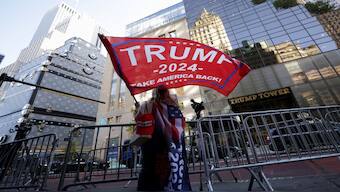 A person waves a Trump flag outside Trump Tower, after U.S. President-elect Donald Trump won the presidential election, in New York City, US, November 6, 2024.  Reuters