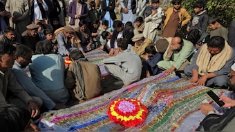 Mourners pray at the burial of the victims of Thursday’s attack. X