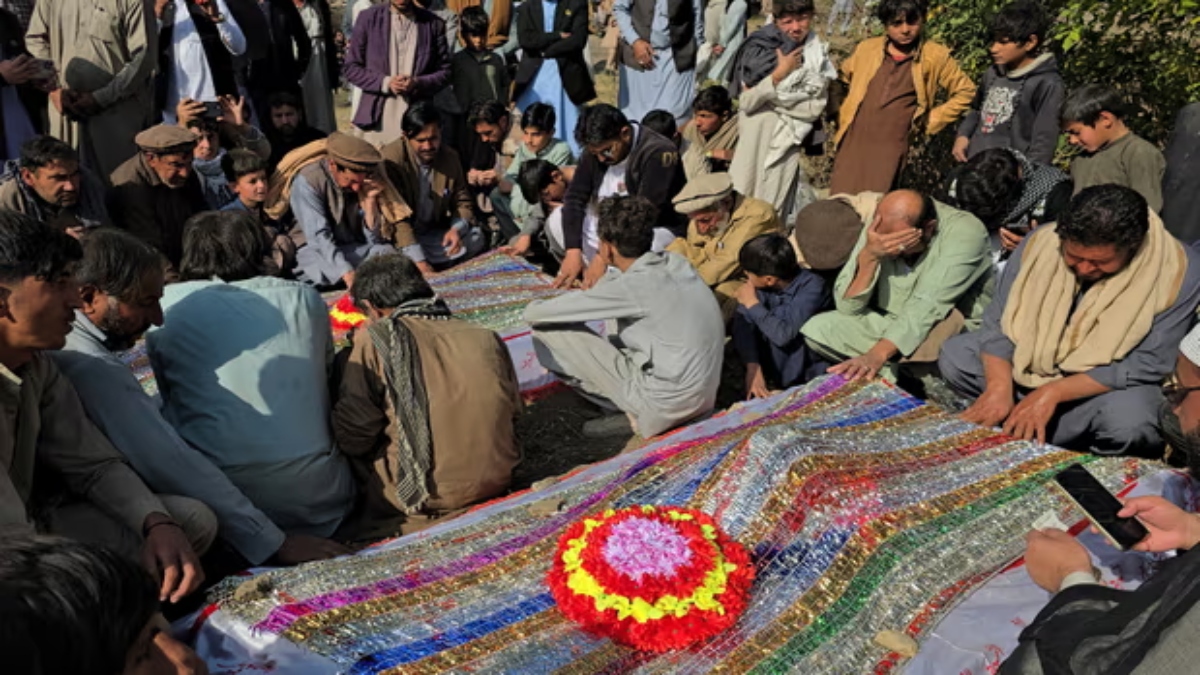 Mourners pray at the burial of the victims of Thursday’s attack. X Mourners pray at the burial of the victims of Thursday’s attack. X