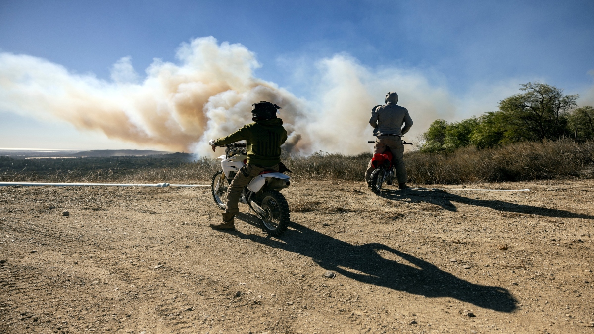 Inhabitants on dirt bikes look at the Mountain Fire’s plume and fire helicopters as it scorches acres, the wildfire fueled by strong Santa Ana winds, in Santa Paula, California, on November 7, 2024. AFP Inhabitants on dirt bikes look at the Mountain Fire’s plume and fire helicopters as it scorches acres, the wildfire fueled by strong Santa Ana winds, in Santa Paula, California, on November 7, 2024. AFP