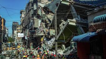 Emergency crews and first responders gather for rescue operations at the site of a collapsed four-story building in Dar es Salaam on November 16, 2024. AFP
