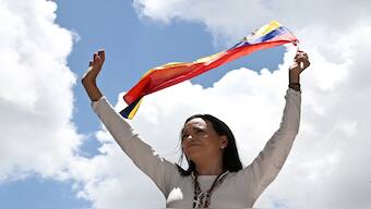Venezuelan opposition leader Maria Corina Machado waves a Venezuelan flag during a rally in Caracas on August 28, 2024. File Image / AFP