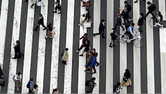  People walk along a pedestrian crossing at Ginza shopping street in Tokyo, on March 31, 2023, in Tokyo.  AP