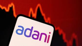 Illustration shows Adani logo and decreasing stock graph. Source: Reuters. 