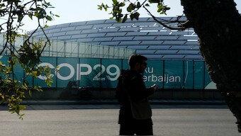 A person walks outside the Baku Olympic Stadium, the venue for the COP29 U.N. Climate Summit, Sunday, Nov. 10, 2024, in Baku, Azerbaijan. AP