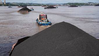 Tug boats pull barges fully loaded with coal on the Mahakam River in Samarinda, East Kalimantan, Indonesia. File image/ AP