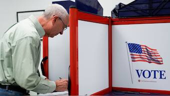 A person marks their ballot at the polling place at Tysons-Pimmit Regional Library in Falls Church. AP