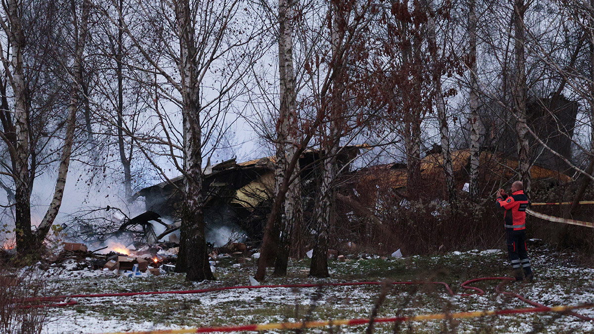 A Lithuanian medic takes a photo on his mobile phone of the wreckage of a cargo plane following its crash near the Vilnius International Airport in Vilnius on November 25, 2024. AFP A Lithuanian medic takes a photo on his mobile phone of the wreckage of a cargo plane following its crash near the Vilnius International Airport in Vilnius on November 25, 2024. AFP