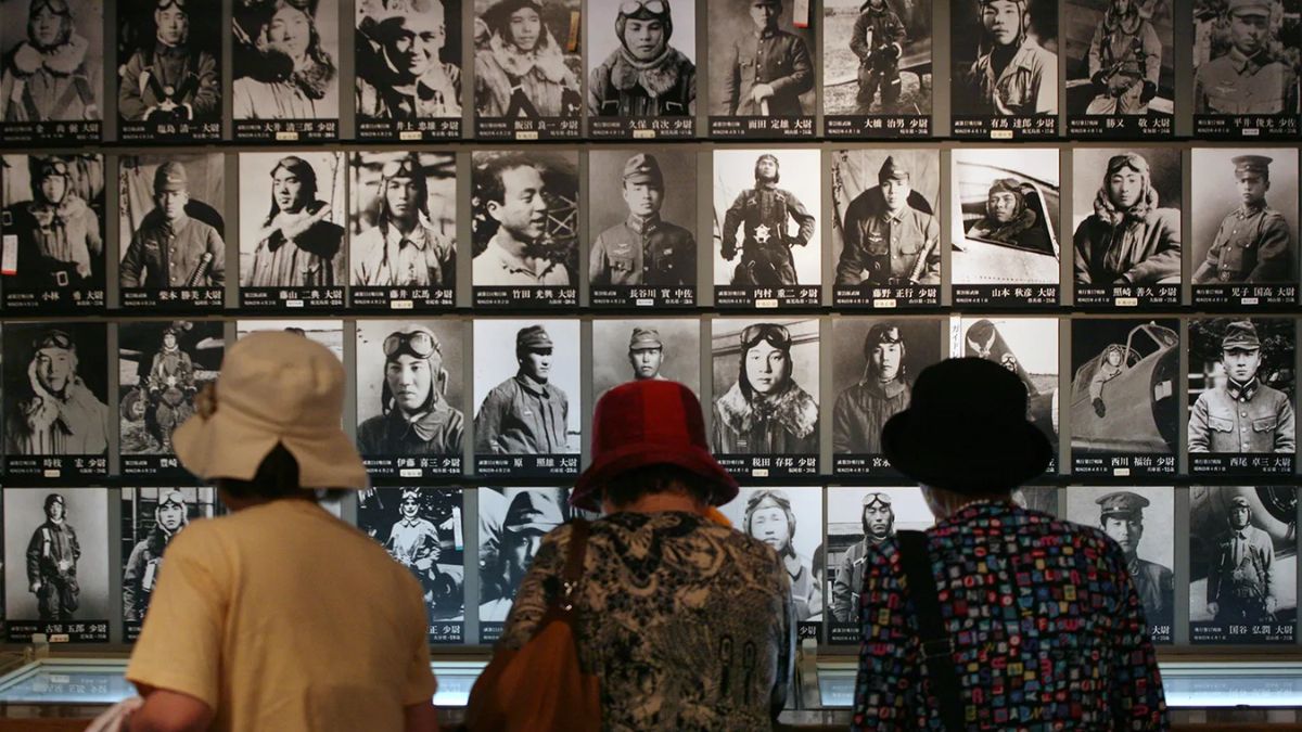 Three people look at photos of Japanese kamikaze pilots in a museum display in Chiran on June 6, 2007. (Photo: AP) Three people look at photos of Japanese kamikaze pilots in a museum display in Chiran on June 6, 2007. (Photo: AP)