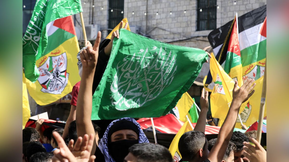 People wave Palestinian, Hamas and Fatah flags during a march in support of the people in the Gaza Strip, in the West Bank city of Nablus. AFP People wave Palestinian, Hamas and Fatah flags during a march in support of the people in the Gaza Strip, in the West Bank city of Nablus. AFP
