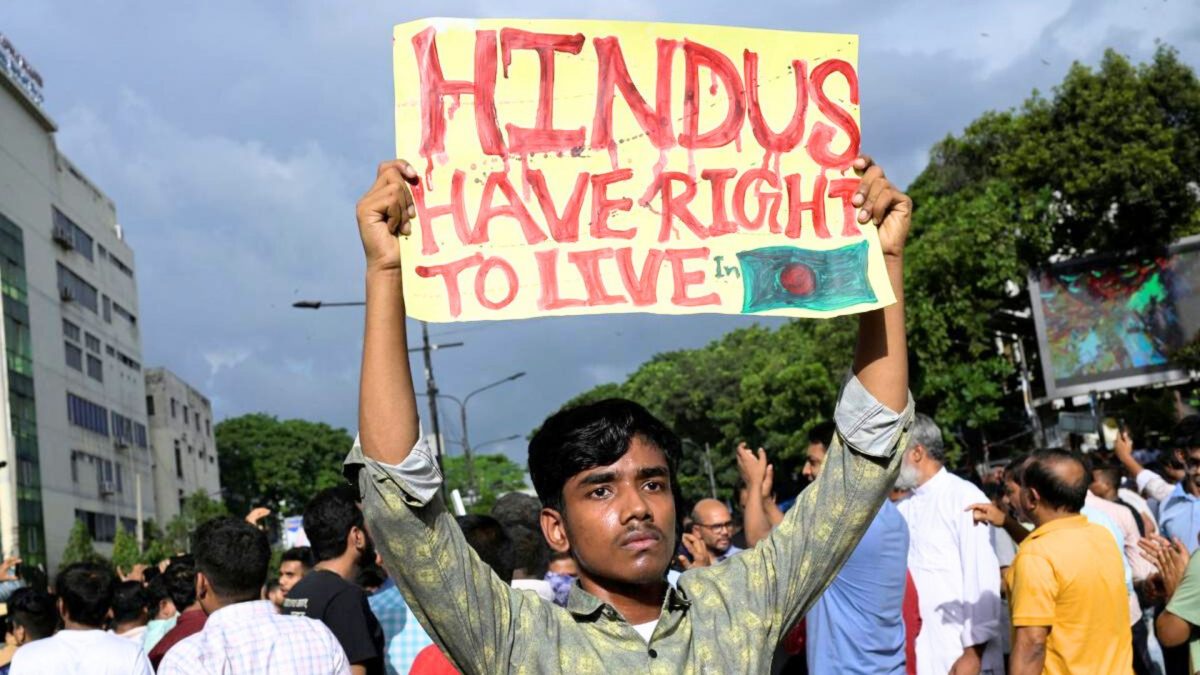 A demonstrator displays a placard during a protest against what they say as violence against Hindu communities during the ongoing unrest, in Dhaka, Bangladesh, on August 9, 2024. Source: Reuters. A demonstrator displays a placard during a protest against what they say as violence against Hindu communities during the ongoing unrest, in Dhaka, Bangladesh, on August 9, 2024. Source: Reuters.