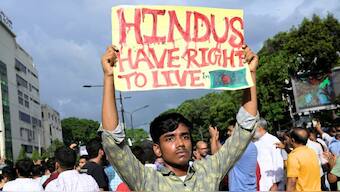 A demonstrator displays a placard during a protest against what they say as violence against Hindu communities during the ongoing unrest, in Dhaka, Bangladesh, on August 9, 2024. Source: Reuters.