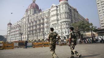 Indian police officers walk outside the Taj Mahal Hotel, one of the sites of the Mumbai terror attacks in Mumbai, India. File image/ AP