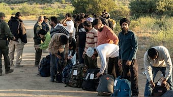 Migrants from India and other countries prepare to be transported to a staging area near the border wall in Jacumba Hot Springs, California. Source: Reuters | Representative Image.