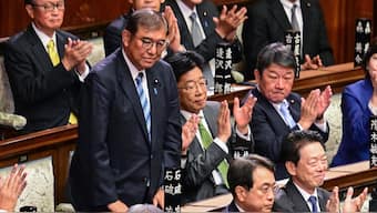 Lawmakers applaud as Japan's Prime Minister Shigeru Ishiba (standing Left) is reappointed as leader after the second round of a parliamentary vote to nominate a prime minister following the October 27 general election, during a special session of parliament in Tokyo on November 11, 2024. Source: AFP.