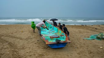 Fishermen anchor a boat during rain at Marina beach, along the coast of the Bay of Bengal in Chennai, Tuesday, November 26, 2024. PTI