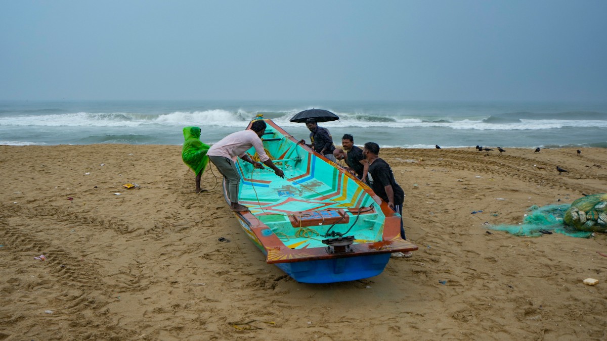 Fishermen anchor a boat during rain at Marina beach, along the coast of the Bay of Bengal in Chennai, Tuesday, November 26, 2024. PTI Fishermen anchor a boat during rain at Marina beach, along the coast of the Bay of Bengal in Chennai, Tuesday, November 26, 2024. PTI