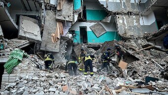 In this photo provided by the Ukrainian Emergency Services on Nov. 19, 2024, rescue workers clear the rubble of a residential building destroyed by a Russian strike in Hlukhiv, Ukraine Image- AP