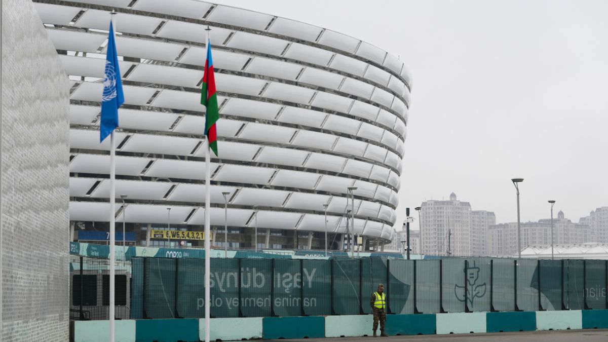 A member of security stands with the Baku Olympic Stadium in the background during the COP29 U.N. Climate Summit, Saturday, Nov. 23, 2024, in Baku, Azerbaijan. Image- AP A member of security stands with the Baku Olympic Stadium in the background during the COP29 U.N. Climate Summit, Saturday, Nov. 23, 2024, in Baku, Azerbaijan. Image- AP