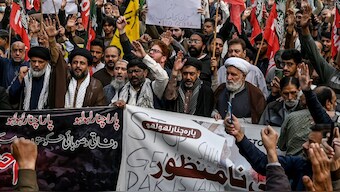 Shiite Muslims hold placards and shout slogans during a protest march against the sectarian attacks in Kurram district in Parachinar, the mountainous Khyber Pakhtunkhwa province, in Lahore on November 22, 2024.  Image- AFP