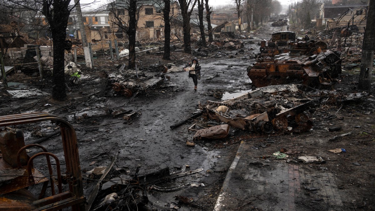 A woman walks amid destroyed Russian tanks in Bucha, in the outskirts of Kyiv, Ukraine. File image/ AP A woman walks amid destroyed Russian tanks in Bucha, in the outskirts of Kyiv, Ukraine. File image/ AP