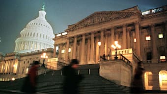 Tourists walk alongside the steps leading up to the US Senate chambers in Washington, US, December 29, 1998. File Image/Reuters