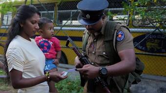 A police officer checks the voter slip of a woman as she arrives to vote on the day of the parliamentary election, in Colombo, Sri Lanka, November 14, 2024. Source: Reuters.