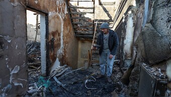 A resident stands inside of his house destroyed by a Russian drone strike, amid Russia's attack on Ukraine, in Odesa, Ukraine. Reuters