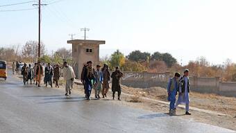 Afghans walk towards a football stadium ahead of the public execution of a man, by the Taliban at Gardez in Paktia province on November 13, 2024. AFP