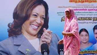A woman walks past a banner of US Vice President Kamala Harris installed alongside a road in the village of Thulasendrapuram, where Harris's maternal grandfather was born more than a century ago, in the southern state of Tamil Nadu, July 27, 2024. File Photo/Reuters