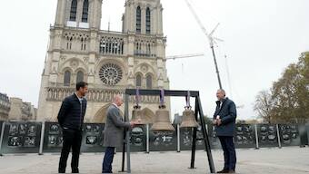 The Director of the Cornille Havard bell foundry Paul Bergamo (C), next to the French President of the Paris 2024 Olympics and Paralympics Organising Committee (COJO) Tony Estanguet (L) and the Rector-Archbishop of Notre-Dame cathedral Monseigneur Olivier Ribadeau Dumas (R), rings the three new bells. AFP