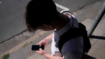 A teenage boy uses his phone in Sydney, November 8, 2024. File Photo/AP