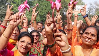 BJP women workers hold lotus while celebrating NDA's win Maharashtra Assembly elections, in Nagpur, November 23, 2024. PTI