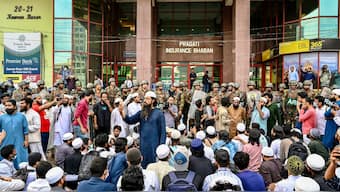 A group of protesters stage a demonstration as Bangladesh Army personnel stand guard in front of the Bangla newspaper Prothom Alo's office in Dhaka on November 25, 2024. AFP