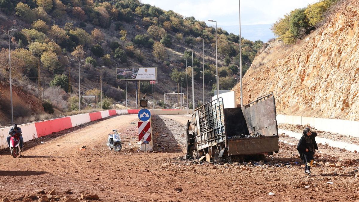 People in Lebanon cross a crater caused by an Israeli strike in the area of Masnaa on the Lebanese side of the border crossing with Syria, on November 20. AFP People in Lebanon cross a crater caused by an Israeli strike in the area of Masnaa on the Lebanese side of the border crossing with Syria, on November 20. AFP