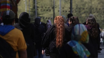 Iranian women walk on a street amid the implementation of the new hijab surveillance in Tehran. Reuters file