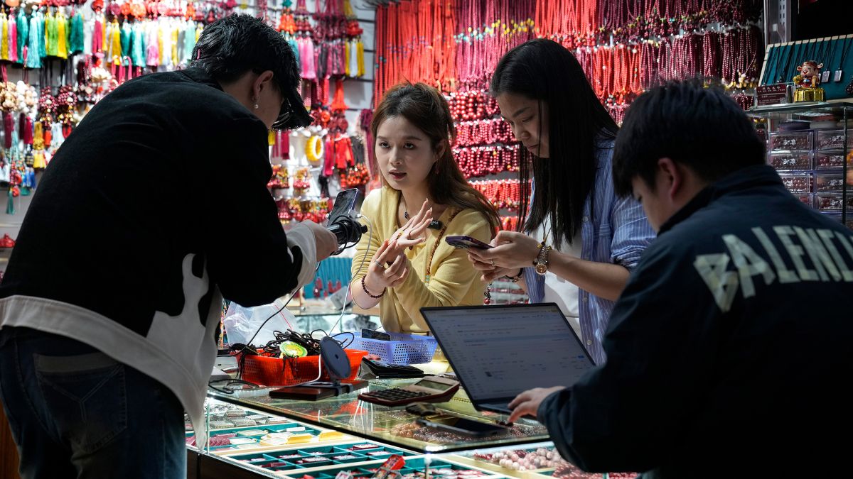 Merchants film their jewellery products for e-commerce sales at their store inside the Yiwu wholesale market in Yiwu, east China's Zhejiang province, Nov. 8, 2024. AP
Merchants film their jewellery products for e-commerce sales at their store inside the Yiwu wholesale market in Yiwu, east China's Zhejiang province, Nov. 8, 2024. AP