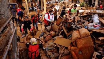 Volunteers help firefighters remove mud from a basement, in the aftermath of floods caused by heavy rains, in Alfafar, near Valencia, Spain, November 3, 2024. File Image/Reuters