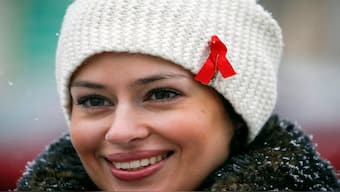 A woman with a red ribbon symbolising the fight against Aids in Kyiv, Ukraine. The red ribbon ha been a symbol of Aids since 1991. File image/Reuters