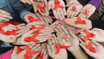 University students hold red ribbons at a photo opportunity during an HIV/Aids awareness rally in Chengdu, Sichuan province. File image/Reuters