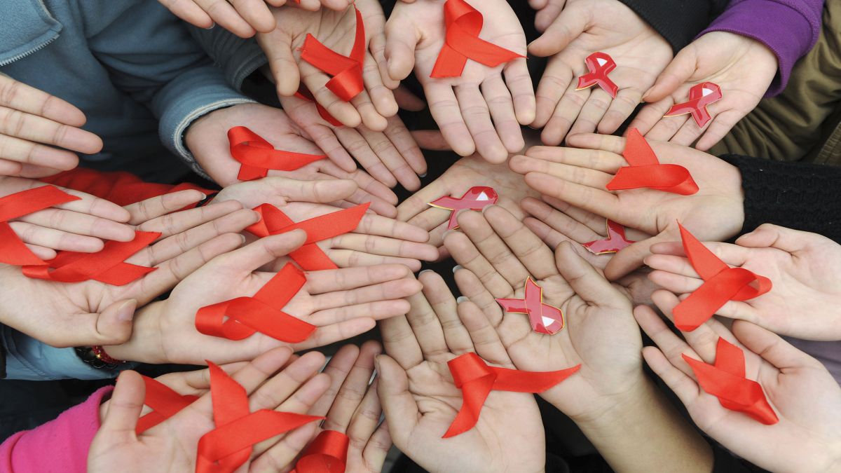 University students hold red ribbons at a photo opportunity during an HIV/Aids awareness rally in Chengdu, Sichuan province. File image/Reuters University students hold red ribbons at a photo opportunity during an HIV/Aids awareness rally in Chengdu, Sichuan province. File image/Reuters