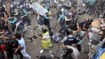 Policemen charge baton to disperse the supporters of Bangladeshi Hindu leader Chinmoy Krishna Das Prabhu after they surrounded police van carrying their leader at the court premises, in Chittagong in southeastern Bangladesh, on Tuesday (November 26). AP