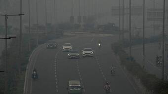 Vehicles move slowly on a highway as smog envelops the area, in Lahore, Pakistan, Oct. 28, 2024. AP
