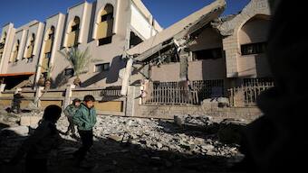 Palestinian children walk at the site of an Israeli strike on a school sheltering displaced people, amid the Israel-Hamas conflict, in Gaza City. Reuters