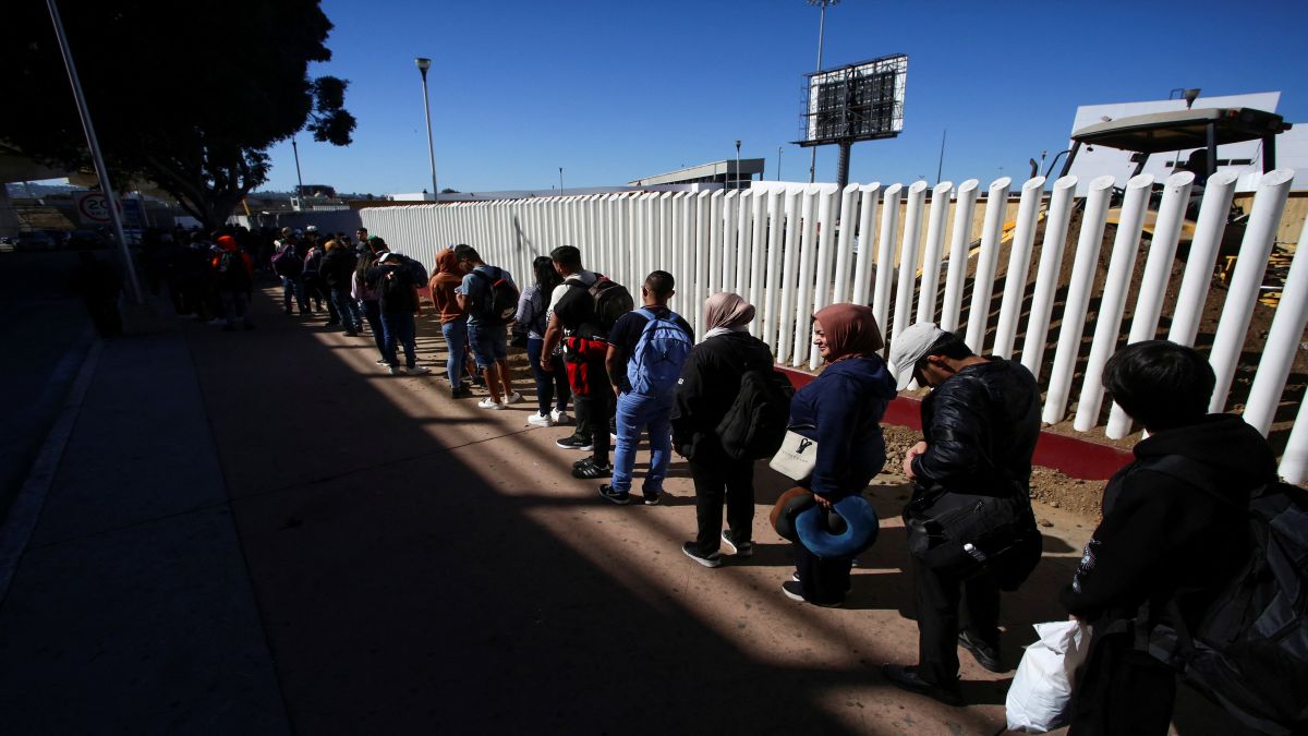 Migrants stand in line to have their papers checked before crossing into the US in Tijuana, Mexico. Reuters Migrants stand in line to have their papers checked before crossing into the US in Tijuana, Mexico. Reuters