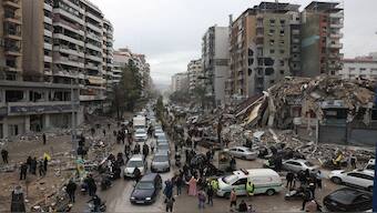 People gather as cars drive past rubble from damaged buildings in Beirut's southern suburbs, after a ceasefire between Israel and Hezbollah took effect at 0200 GMT on Wednesday after US President Joe Biden said both sides accepted an agreement brokered by the United States and France, in Lebanon. Reuters