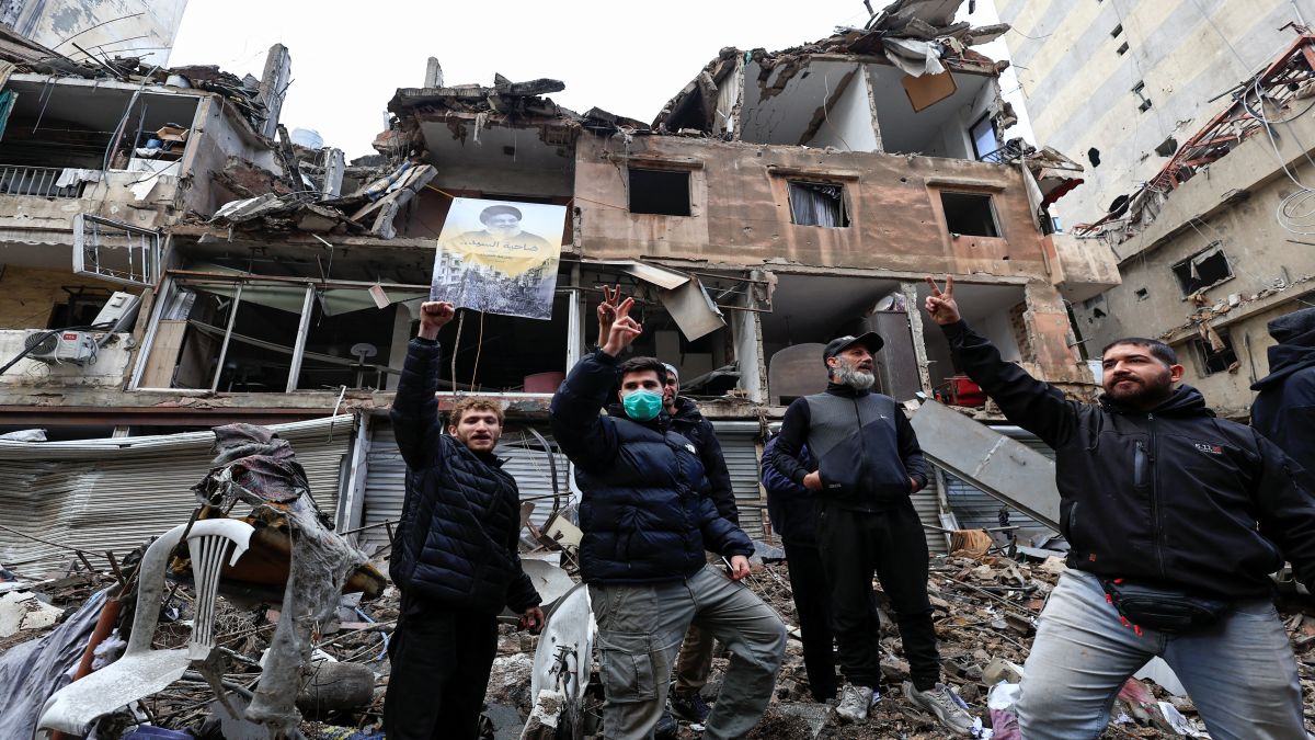 Men gesture in front of buildings damaged in Israeli strikes in Beirut's southern suburbs, after a ceasefire between Israel and Hezbollah took effect. Reuters Men gesture in front of buildings damaged in Israeli strikes in Beirut's southern suburbs, after a ceasefire between Israel and Hezbollah took effect. Reuters