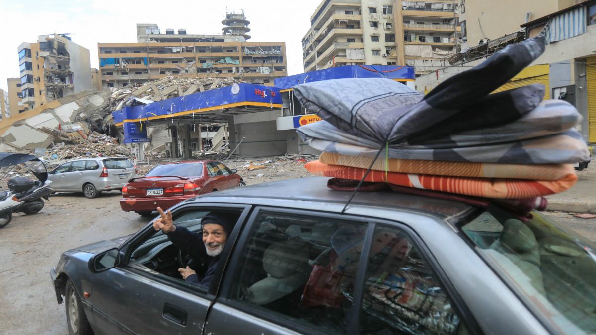 People return with their belongings to their homes in Beirut's southern suburbs after a ceasefire between Israel and Hezbollah took effect. AFP People return with their belongings to their homes in Beirut's southern suburbs after a ceasefire between Israel and Hezbollah took effect. AFP